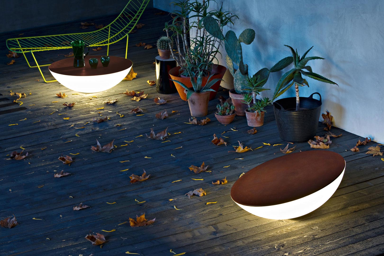 Image of an outdoor wood deck with solar lights with wood tops as end table.