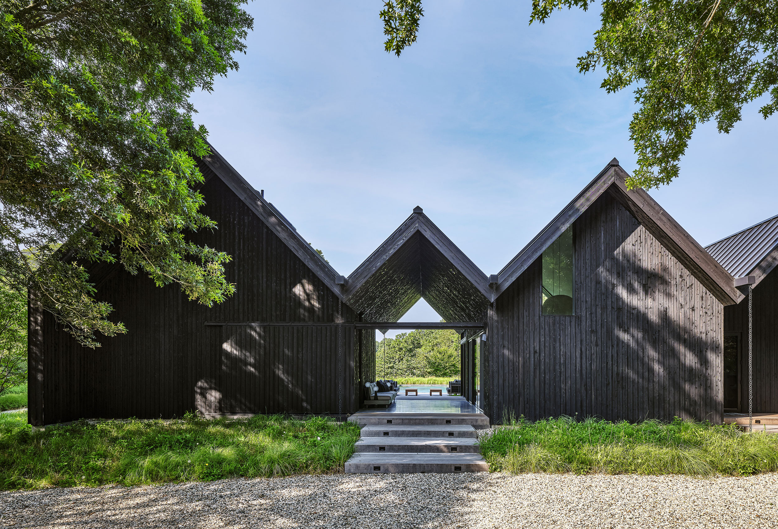 Workshop/APD Clads Contemporary East Hampton Home in Shou Sugi Ban and gravel driveway