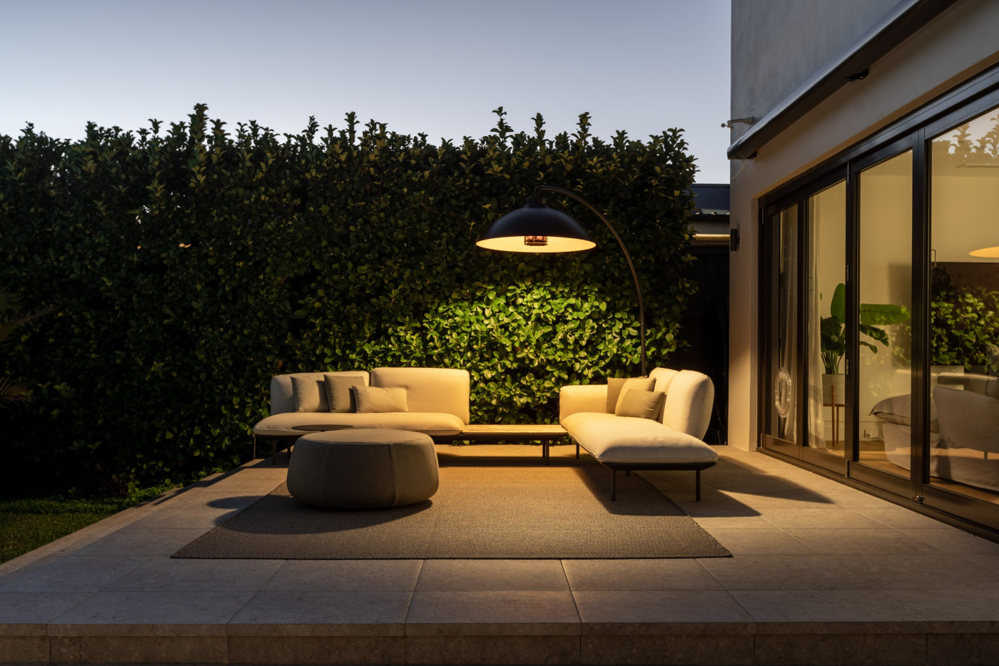 Rolling Stone Landscapes designs outdoor living areas with architectural floor lamp