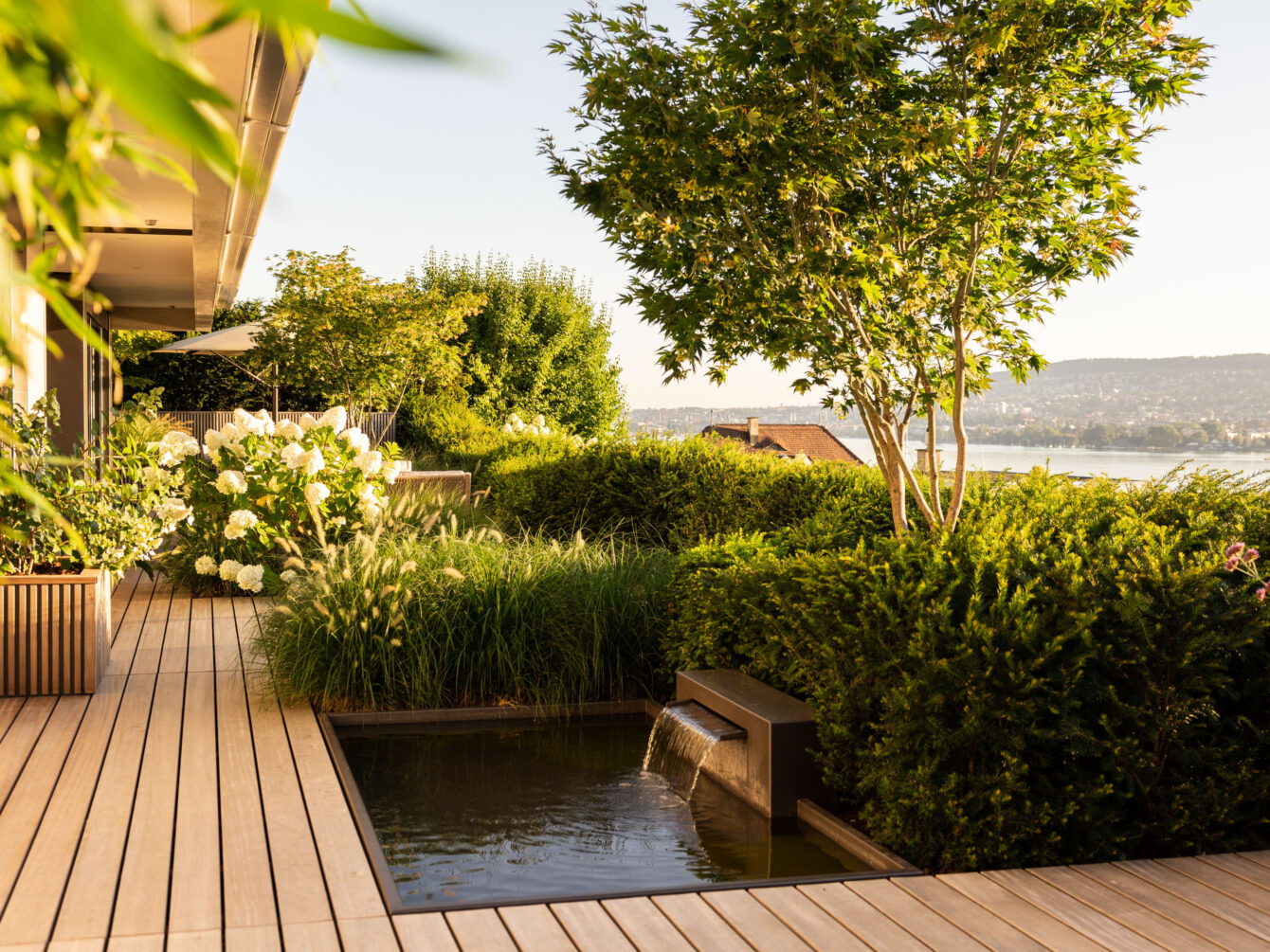 Enea landscape designs water features in the contemporary terrace landscape overlooking lake zurich.