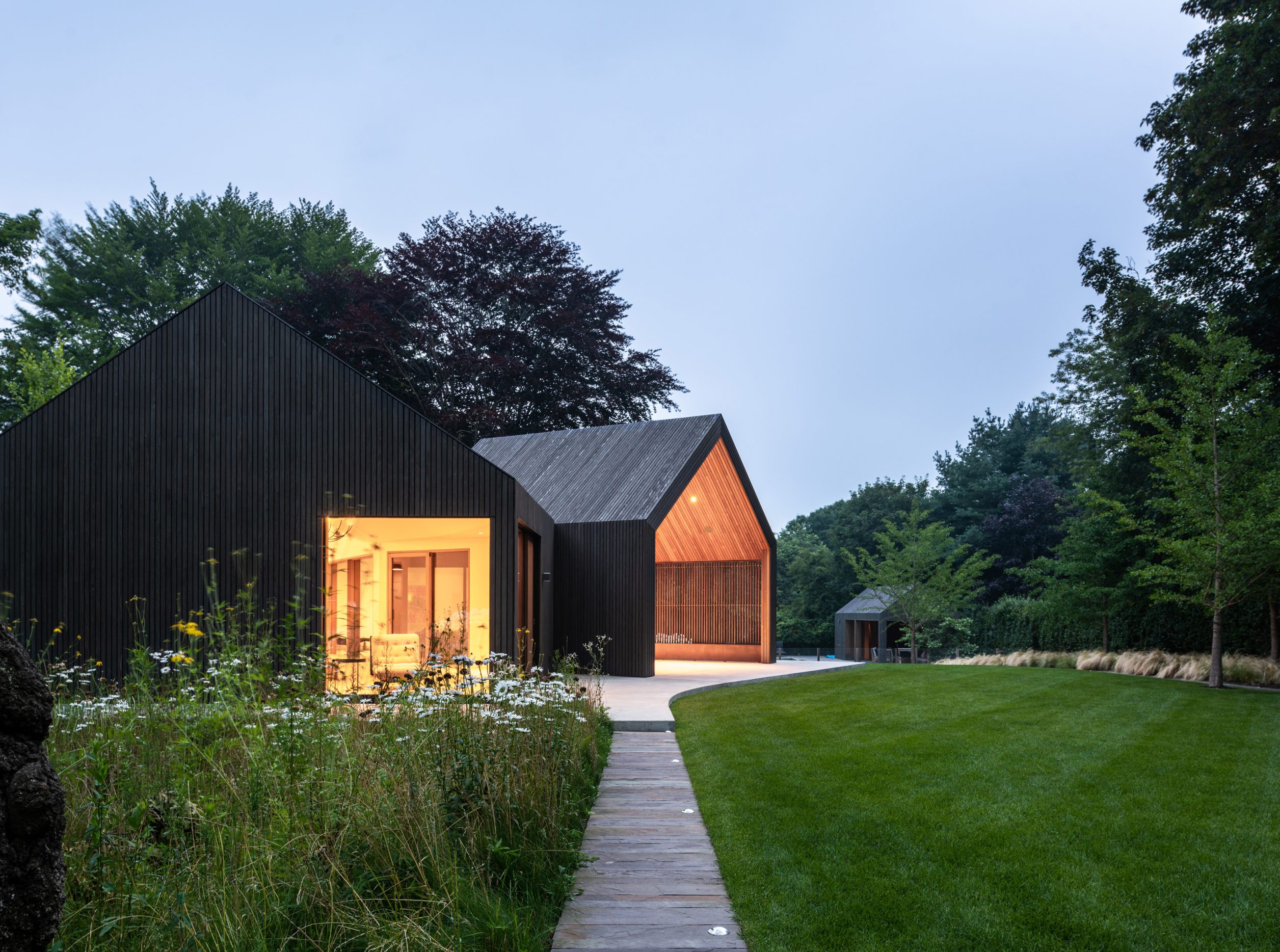A cluster of gabled structures are arranged within the landscape to frame key views in the landscape